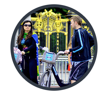 Two London strangers stopping for a conversation whilst walking their Barclays Bikes.
