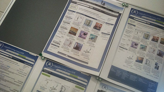 Several ILC NSW screen designs on A3 paper pinned to a board.